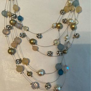 Lovely necklace. Six strands of beads (gold, blue, pearl, rhinestone).